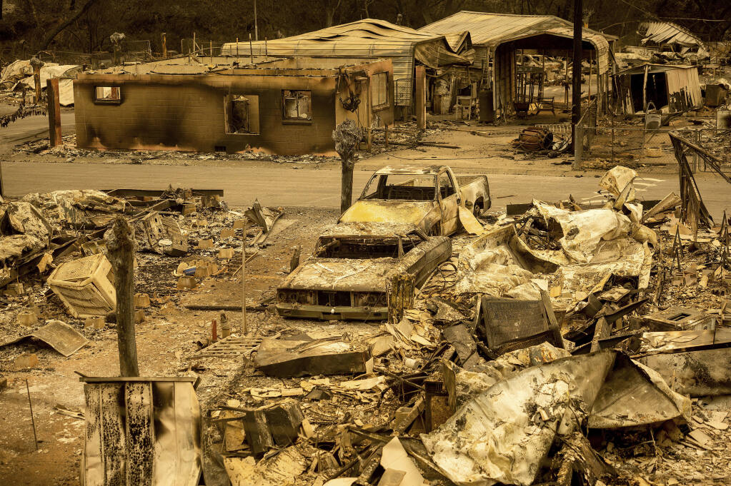 Scorched homes and vehicles fill Spanish Flat Mobile Villa following the LNU Lightning Complex fires in unincorporated Napa County, California, on Thursday, Aug. 20, 2020. The fire destroyed dozens of homes at the mobile home park with only a handful that remained standing. Fire crews across the region scrambled to contain dozens of wildfires sparked by lightning strikes. (Noah Berger/The Associated Press)