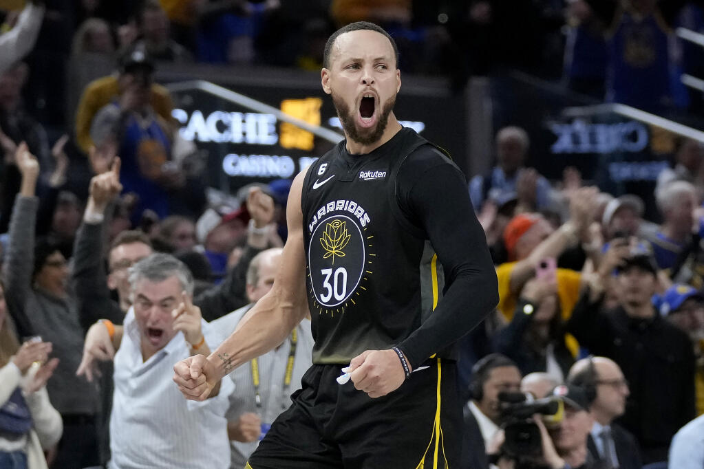 Golden State Warriors guard Stephen Curry celebrates after making a 3-point basket during the second half against the Milwaukee Bucks in San Francisco, Saturday, March 11, 2023. (Jeff Chiu / ASSOCIATED PRESS)