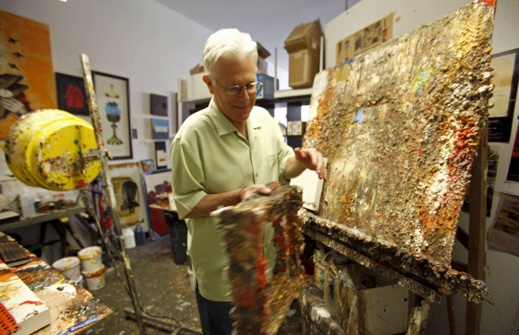 FILE - This Oct. 29, 2009 file photo shows Father Bill Moore with his art in his studio at the Pomona Arts Colony in Pomona, Calif. Father Bill Moore, a Catholic priest and prominent abstract expressionist who spent decades spreading spiritualism through his paintings, has died. He was 71. Longtime friend Tom Irwin says Moore died Sunday, Oct. 18, 2020 of prostate cancer. Seeing his artistic talent, Moore's Southern California parish, the Sacred Hearts of Jesus and Mary, allowed him to spend much of his time painting. (AP Photo/Damian Dovarganes, File)