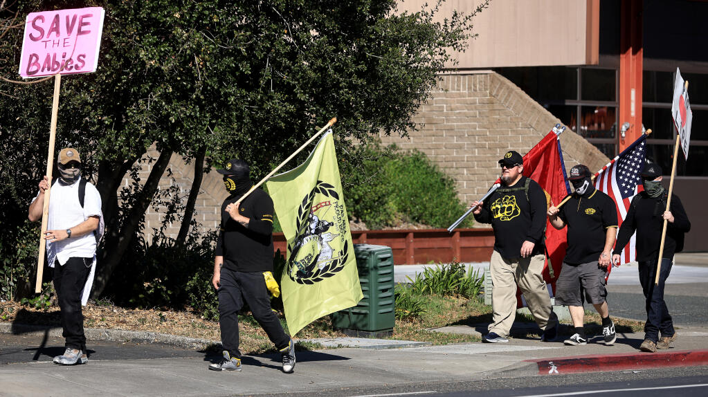 Anti-abortion protesters walk west on Sonoma Avenue after protesting in front of Planned Parenthood in Santa Rosa, Saturday, Feb. 12, 2022, in a rally organized by the Bay Area Proud Boys. (Kent Porter / The Press Democrat)