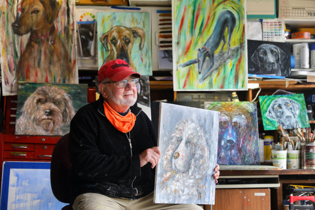 Artist Sig Rundström with some of his Art Dogs series of paintings at his home in Sonoma on Thursday, March 18, 2021.  Over the course of the pandemic, Rundström painted around 50 dog portraits and surprised about 30 owners with paintings.  (Christopher Chung / The Press Democrat)