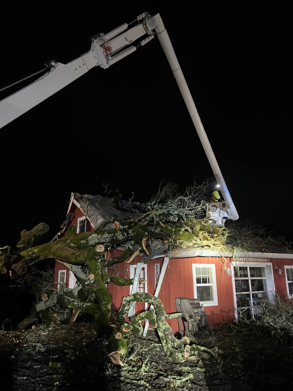 Fine Tree Care of Sebastopol responds to a call to clear fallen tree branches off the roof of a home on Joy Road in Occidental on Friday, Jan. 14, 2023. (Jeff Rebischung / Fine Tree Care photo)