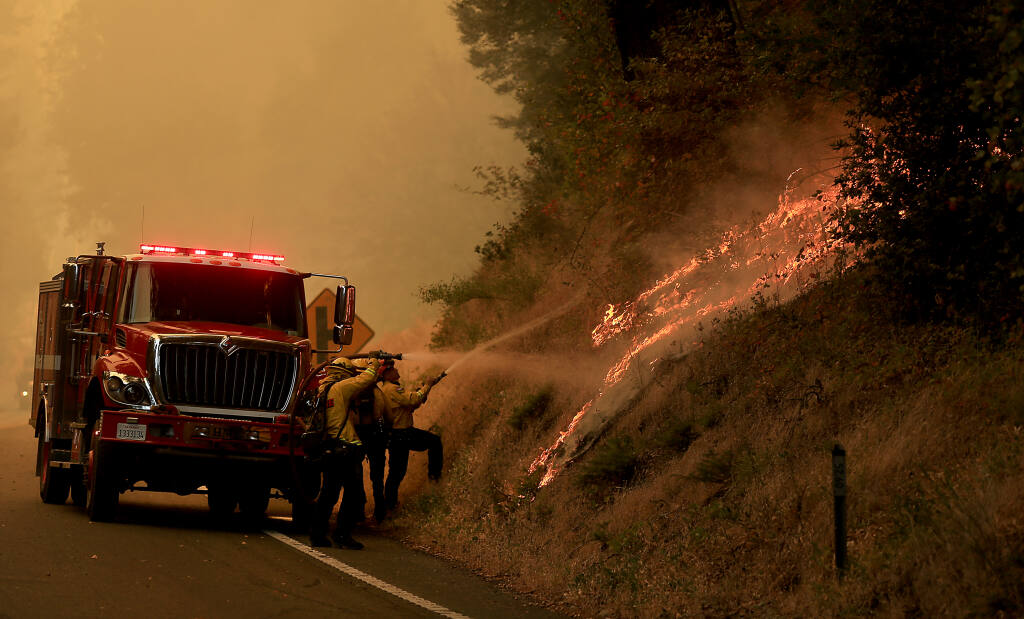 Flames roll up a mountainside along Highway 101 north of Willits, Monday, Sept. 7, 2020, as the Oak fire burns more than 700 acres. (Kent Porter / The Press Democrat)