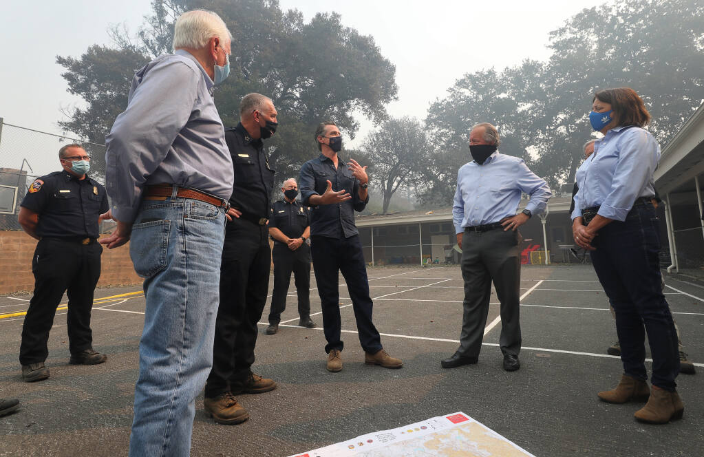 Rep. Mike Thompson, Cal Fire Director Thom Porter, Gov. Gavin Newsom, Sen. Bill Dodd and Assemblywoman Cecilia Aguiar-Curry discuss the Glass fire at Foothills Elementary School near St. Helena on Thursday, Oct. 1, 2020. (Christopher Chung / The Press Democrat)