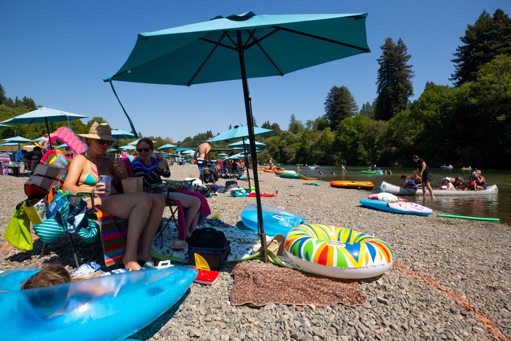 Visitors at Johnson's Beach cool off in the shade beside the Russian River in Guerneville, Saturday, Sept. 5, 2020. (Alvin A.H. Jornada / The Press Democrat file)