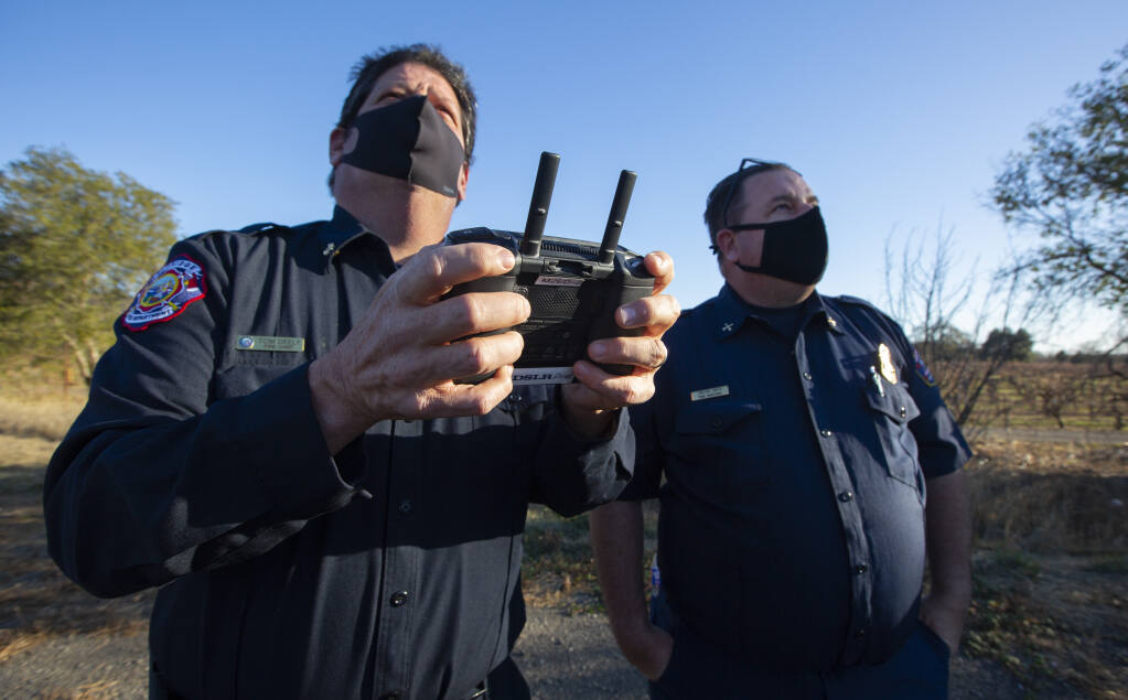 Left, Fire Chief Tom Deely at the drone controls, and Fire Marshal Trevor Smith practice navigating the Sonoma Valley Fire Department’s camera drone on the the SDC grounds on Thursday, Dec. 10. (Photo by Robbi Pengelly/Index-Tribune)