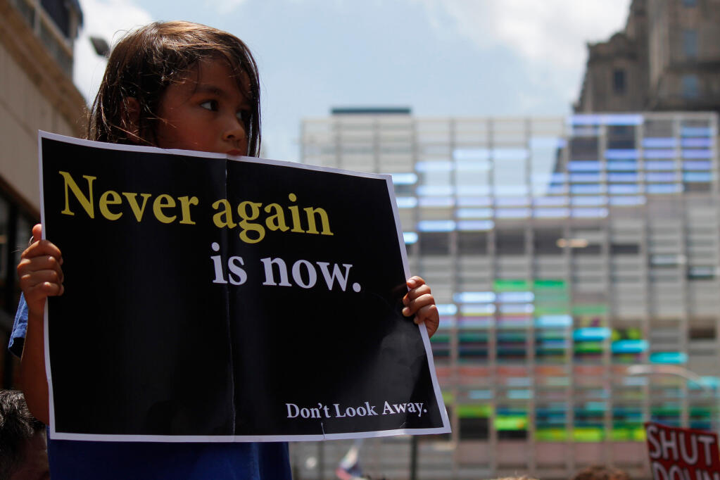 A young girl holds up a protest sign to demand the closure of detention camps at the U.S.-Mexico border. Philadelphia, PA / USA - July 12, 2019.