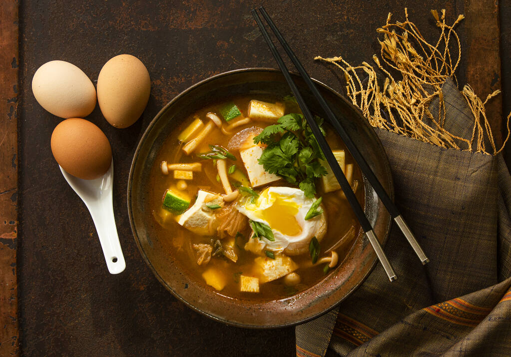 Korean Kimchi Soft Tofu Stew by Chef John Ash is topped with poached eggs. (John Burgess/The Press Democrat)