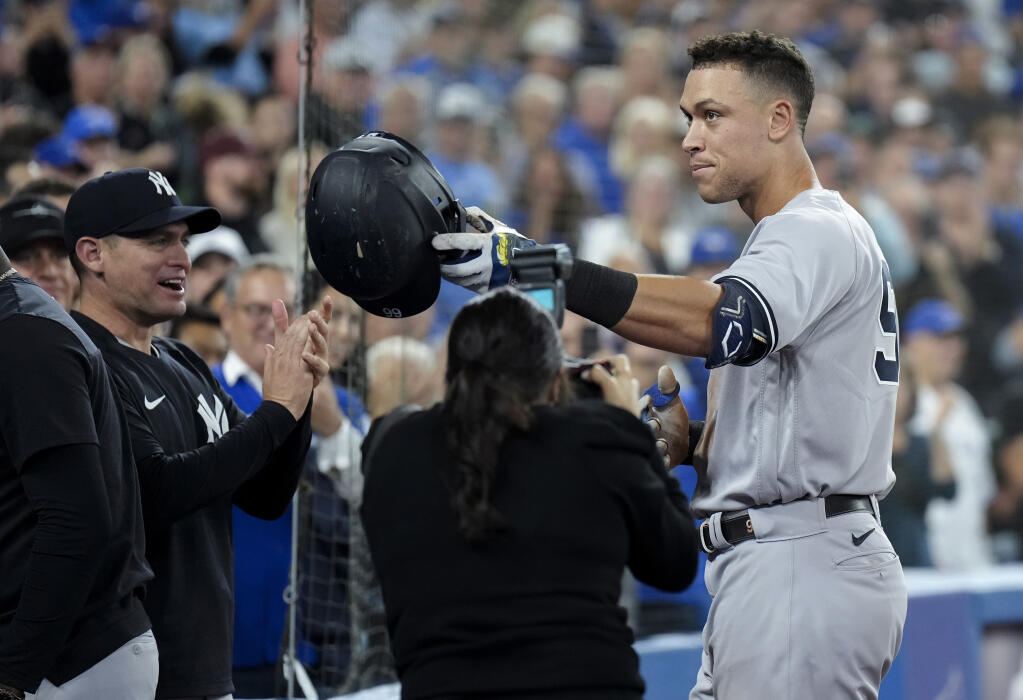 The New York Yankees' Aaron Judge celebrates his 61st home run of the season, a two-run shot against the Toronto Blue Jays, and acknowledges his family during the seventh inning Wednesday, Sept. 28, 2022, in Toronto. (Nathan Denette/The Canadian Press via AP)