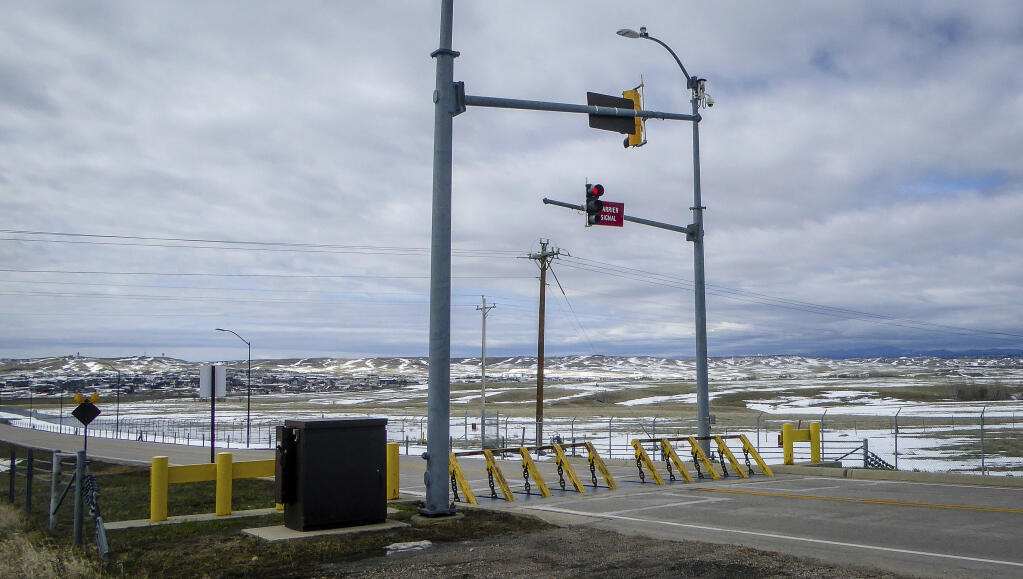 FILE - An emergency vehicle barrier at Ellsworth Air Force Base in Rapid City, S.D., on May 2, 2019. Under a proposed rule change, foreign citizens and companies would need U.S. government approval to buy property within 100 miles of eight military bases. The new rule would affect Ellsworth and seven other bases, including three that are tied to the B-21 Raider (Arielle Zionts/Rapid City Journal via AP, File)