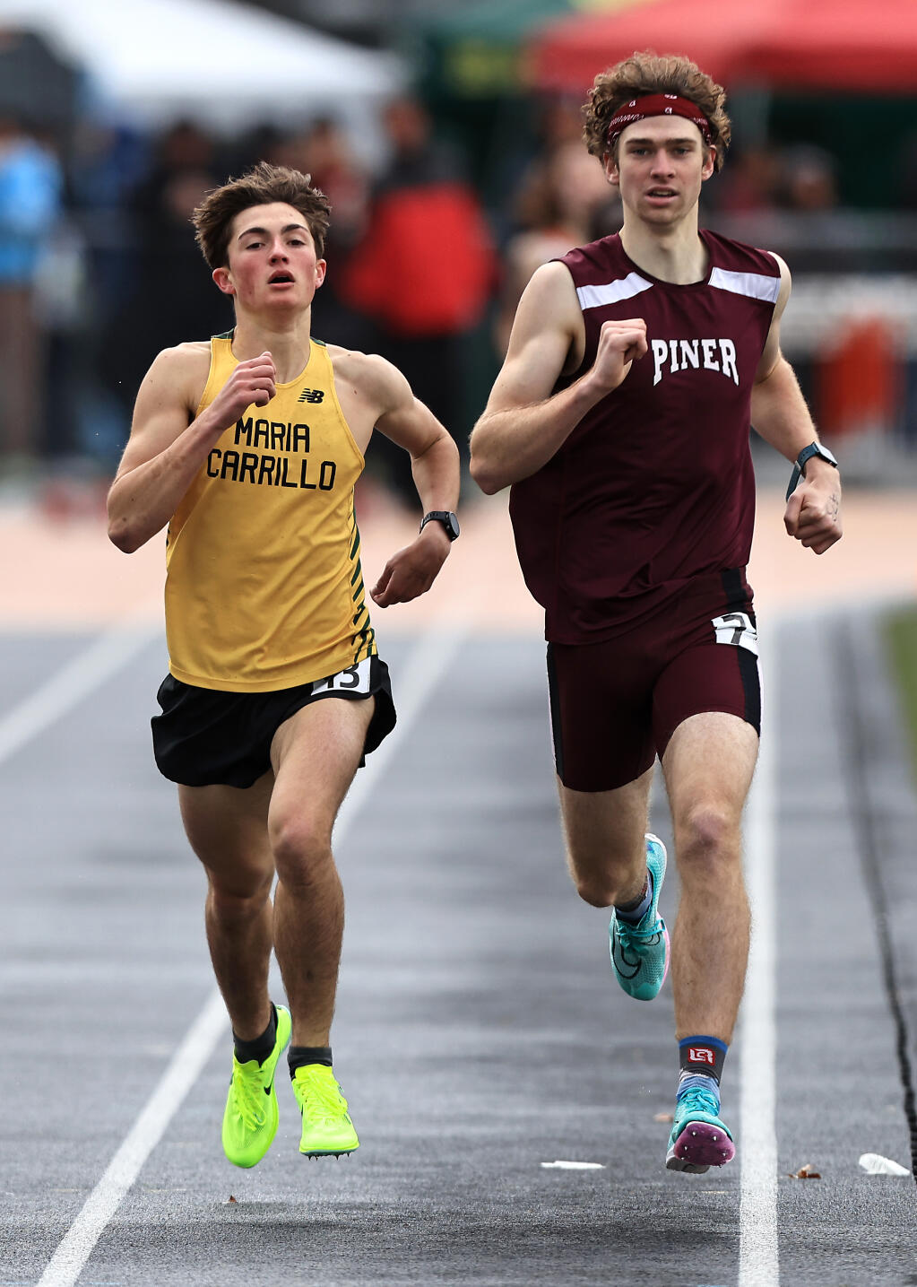 Piner High School’s Jared Hayes, right, edges Maria Carrillo’s Jack Wilson for the top spot in the boys varsity 1600 meter run, during the Big Cat Invitational at Santa Rosa High School, Saturday, March 4, 2023. (Kent Porter / The Press Democrat) 2023