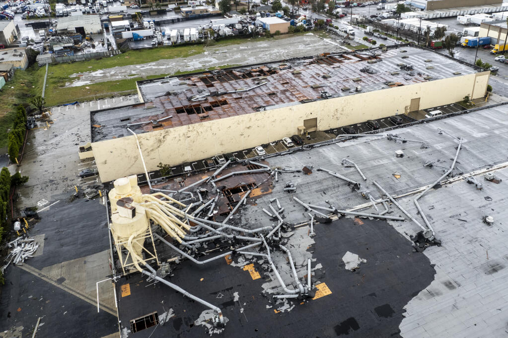 Damage to a building is seen on Wednesday, March 22, 2023 in Montebello, Calif., after a possible tornado. (AP Photo/Ringo H.W. Chiu)