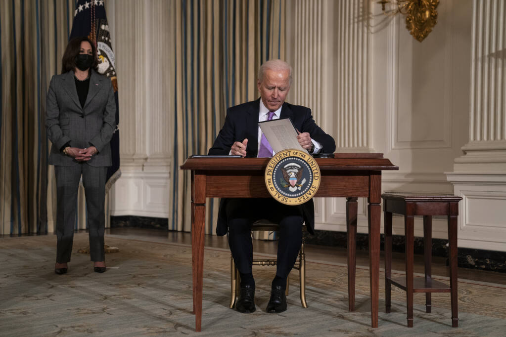 Vice President Kamala Harris looks on Tuesday as President Joe Biden signs a series of executive orders on racial equity,. (EVAN VUCCI / Associated Press)