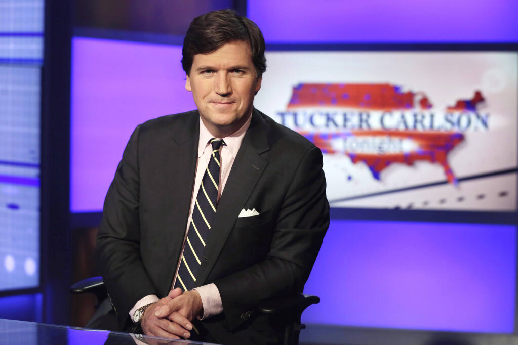 FILE - Tucker Carlson, host of "Tucker Carlson Tonight," poses for photos in a Fox News Channel studio on March 2, 2017, in New York. Fired Fox news host Carlson said Tuesday, May 9, 2023, that he will be putting out a “new version” of his program on Twitter. (AP Photo/Richard Drew, File)