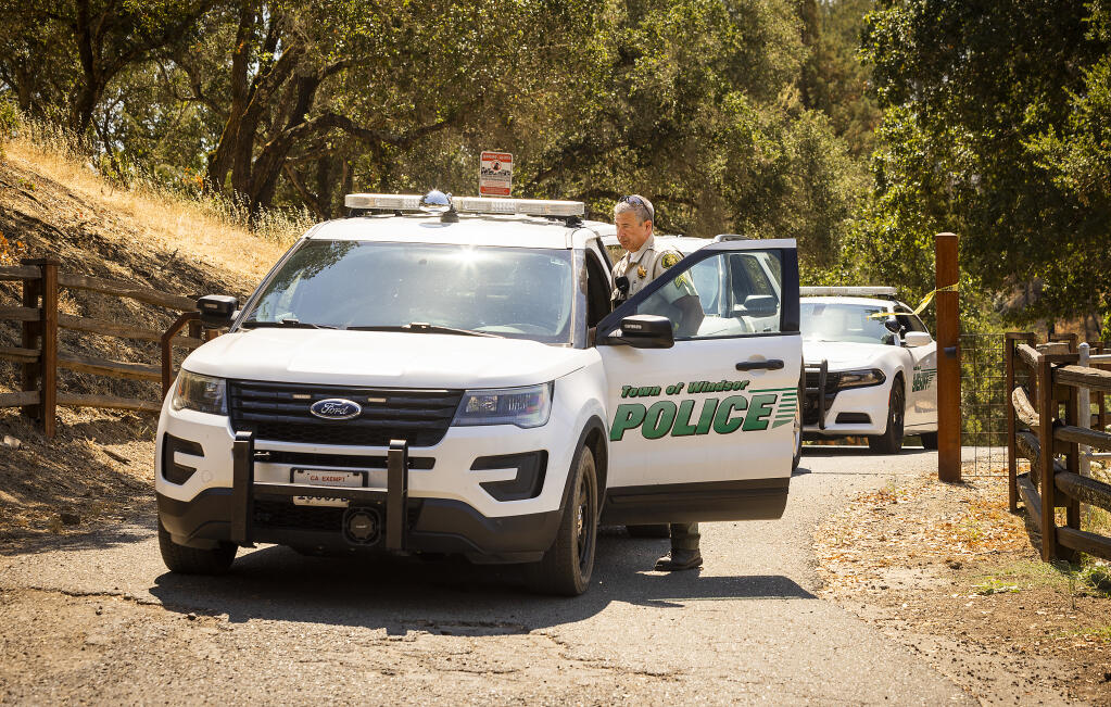 Windsor Police and Sonoma County Sheriff vehicles leave the site of a fatal shooting north of Windsor on Friday, July 29, 2022. Officials say a Sonoma County sheriff's deputy fatally shot someone.  (John Burgess/The Press Democrat)