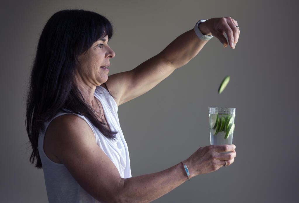 Dietician Joyce Giammattei flavors a glass of water with cucumber slices at the Sonoma Valley Community Health Center on Wednesday, Sept. 21 2022. (Robbi Pengelly/Index-Tribune)