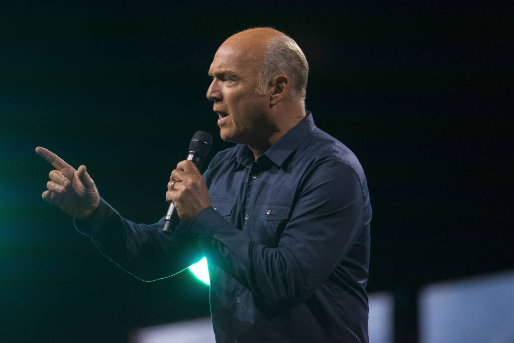 FILE - In this Aug. 18, 2017, file photo, Greg Laurie delivers his sermon during the opening night of Harvest Crusade at Angel Stadium in Anaheim, Calif. Laurie, of Harvest Christian Fellowship in Riverside, said Monday, Oct. 5, 2020, that he tested positive for the coronavirus and is in quarantine. Laurie says his symptoms are mild and he expects to make a full recovery. (Matt Masin/The Orange County Register via AP, File)