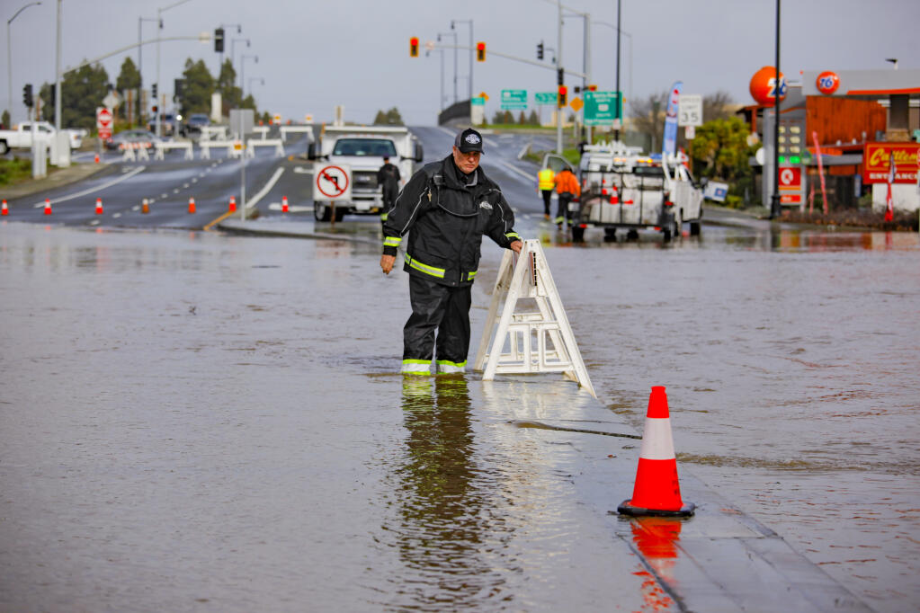 Don Horner, assistant operation manager for the city of Petaluma, puts up barricades and cones along North Petaluma Boulevard where recent rains caused flooding in the area. The roads were closed to traffic on Monday, January 9, 2023. (CRISSY PASCUAL/ARGUS-COURIER STAFF)
