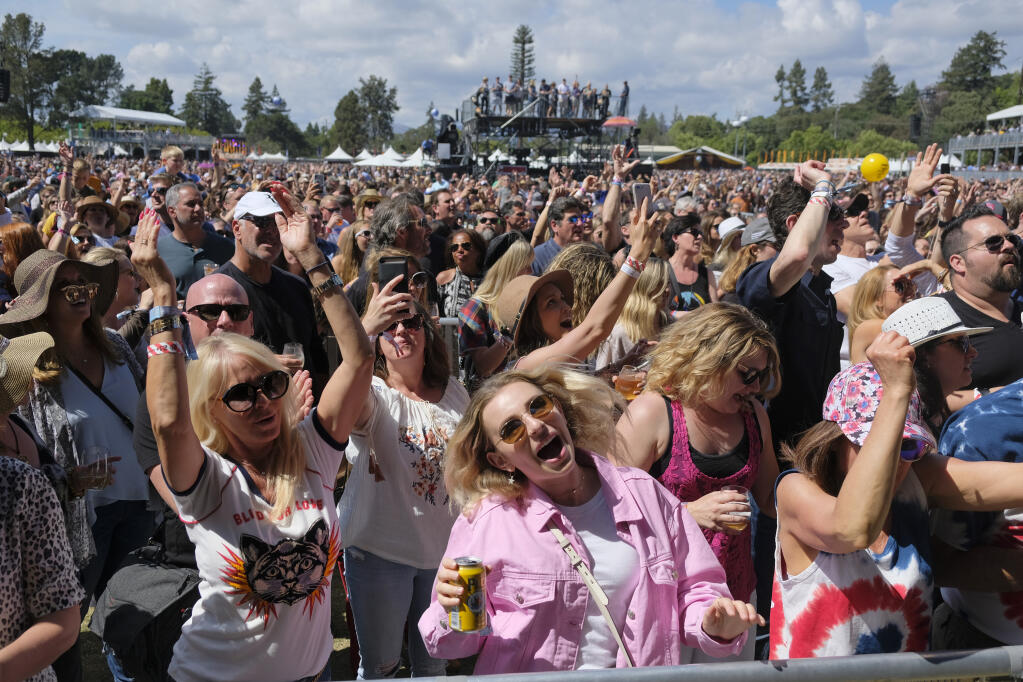In this May 26, 2018, file photo, people listen to Michael Franti perform at the BottleRock Napa Valley music festival in Napa, California. This year's event has been rescheduled for Sept. 3-5.  (Eric Risberg/Associated Press, file)