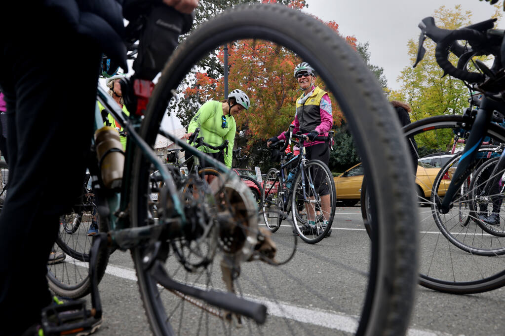 Jessica Henderson, left, and Sue Bennett tether before the start of a ride in Sebastopol, California hosted Sunday, October 16, 2022, by the Sonoma County Biker Chicks, a group within the Sonoma County Bicycle Coalition. (Beth Schlanker/The Press Democrat)