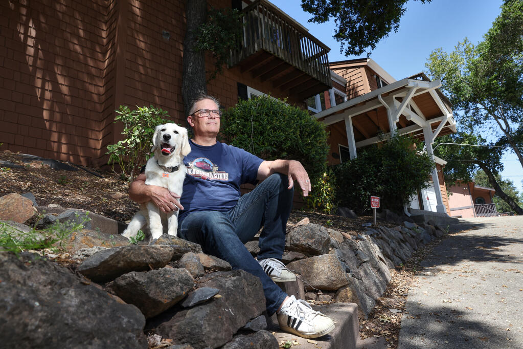 Gary Lentz, with his dog Ryker, owns two vacation rental properties in Santa Rosa.  Lentz is opposed to proposed recommendations that the city limit the number of rentals one person can own to one hosted, and one non-hosted rental property.  Photo taken on Friday, April 28, 2023.  (Christopher Chung/The Press Democrat)
