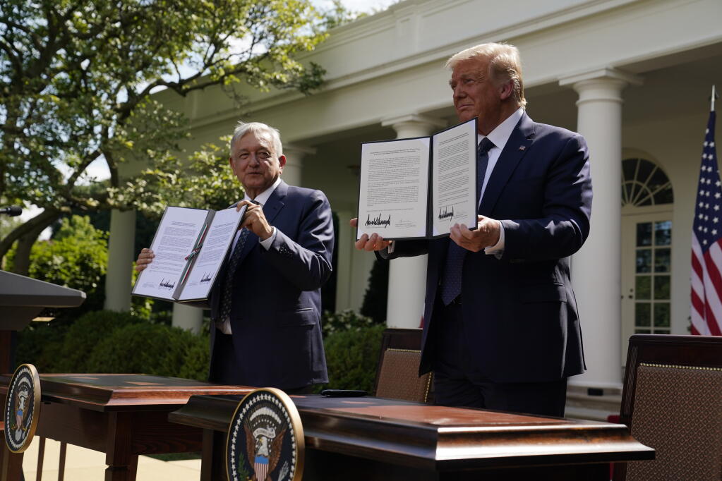 President Donald Trump and Mexican President Andres Manuel Lopez Obrador pose for photos after signing a joint declaration at the White House, Wednesday, July 8, 2020, in Washington. (AP Photo/Evan Vucci)
