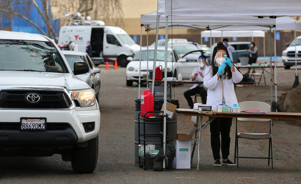 Safeway pharmacy graduate intern Nancy Kong prepares a syringe with the Moderna COVID-19 vaccination during a drive-thru vaccination event for in-home supportive services personnel in Santa Rosa on Wednesday, Jan. 13, 2021.(Christopher Chung / The Press Democrat)