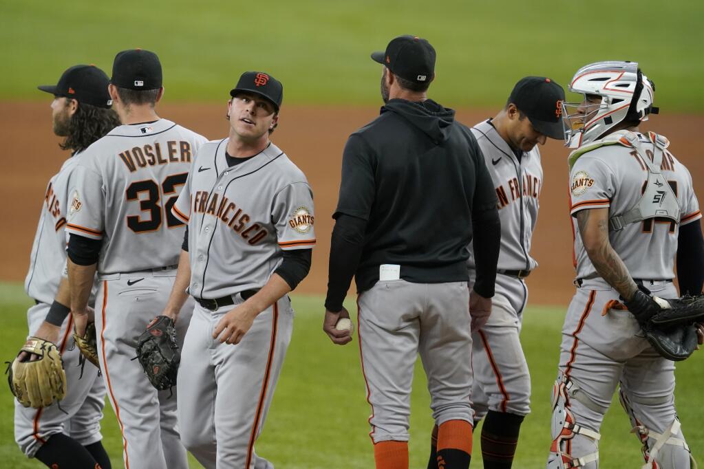 San Francisco Giants relief pitcher Sammy Long, third from left, leaves the mound after turning over the ball to manager Gabe Kapler in the sixth inning against the Texas Rangers in Arlington, Texas, on Wednesday, June 9, 2021. (Tony Gutierrez / ASSOCIATED PRESS)