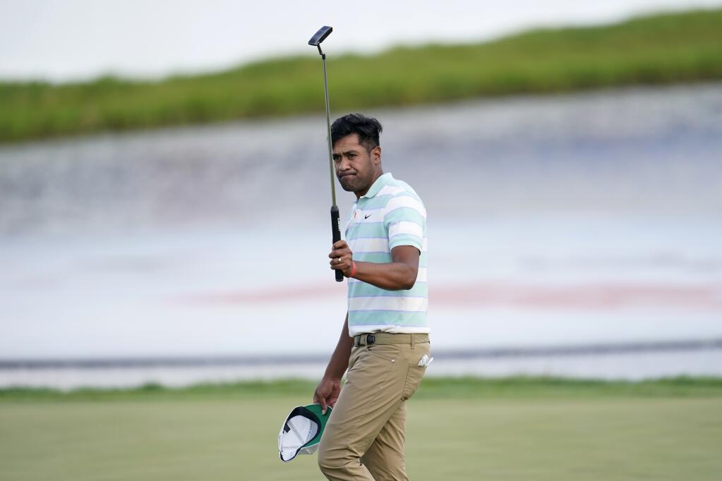Tony Finau acknowledges applause from the gallery after his win in the 3M Open golf tournament at the Tournament Players Club in Blaine, Minn., Sunday, July 24, 2022. (AP Photo/Abbie Parr)