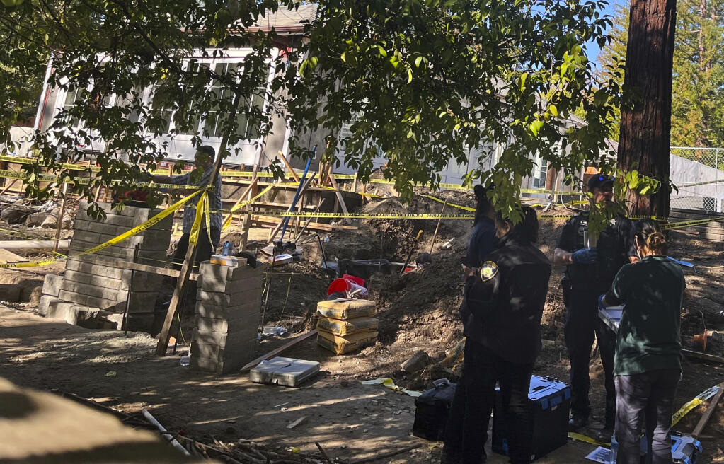 Atherton police continue to investigate the discovery of a vehicle found buried in the yard of a home in the 300 block of Stockbridge Avenue in Atherton, Calif., Friday, Oct. 21, 2022. (Julia Prodis Sulek/Bay Area News Group via AP)