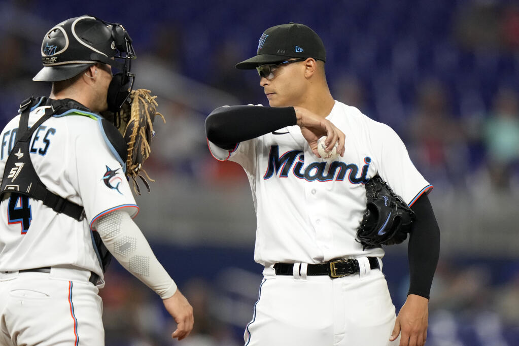 Miami Marlins catcher Nick Fortes, left, talks with starting pitcher Jesus Luzardo during the fifth inning of a baseball game against the San Francisco Giants, Monday, April 17, 2023, in Miami. (AP Photo/Lynne Sladky)