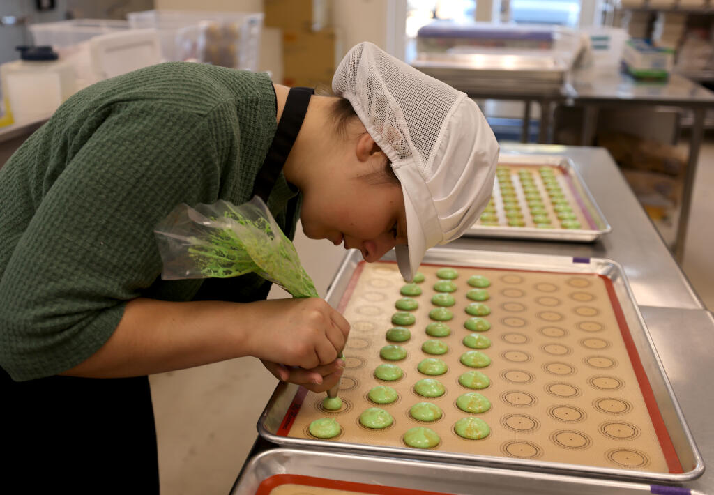 Madeleine’s Macarons baker Giovanna Leonard makes ginger pear macarons at the company’s kitchen in Napa, Monday, Sept. 11, 2023. (Beth Schlanker / The Press Democrat)