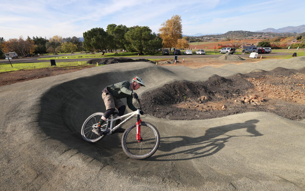Pat Sahs rounds a curve on the new pump track for bicycles at Skyline Wilderness Park in Napa , Sunday, Dec. 10, 2023. (Beth Schlanker / The Press Democrat)