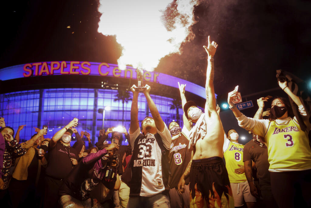 Los Angeles Lakers fans celebrate outside of Staples Center, Sunday, Oct. 11, 2020, in Los Angeles, after the Lakers defeated the Miami Heat in Game 6 of basketball's NBA Finals to win the championship. (AP Photo/Christian Monterrosa)