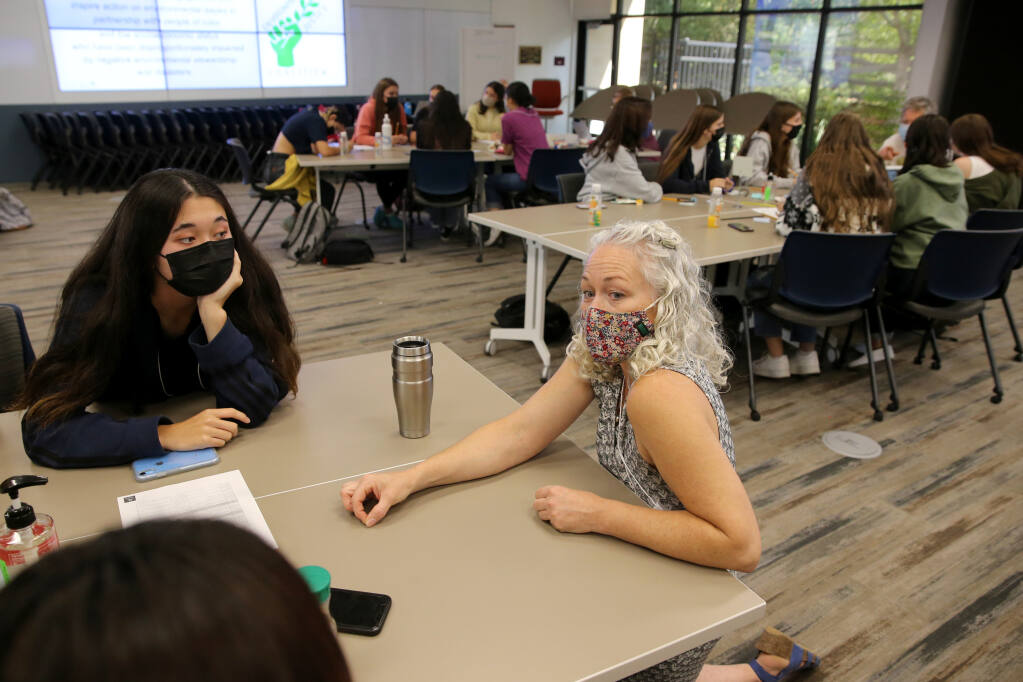 Nichole Warwick of Daily Acts talks with Technology High students including Quinn Shioda during an Environmental Justice Coalition kick-off event at Sonoma County Office of Education in Santa Rosa, Calif., on Thursday, September 23, 2021. (Beth Schlanker/The Press Democrat)
