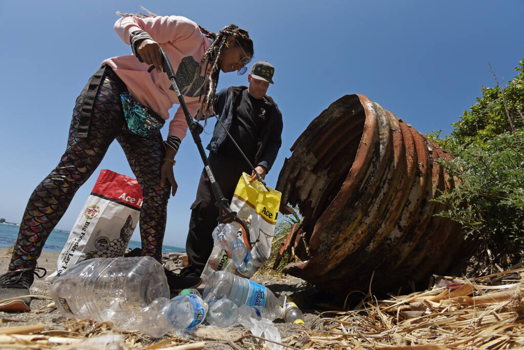 Sierra Wooten, left, with her husband Ryder Wooten removing trash from an old drainage pipe during a monthly Mendocino coast cleanup hosted by the Mendocino Mermaids at Noyo Beach in Fort Bragg, Calif. on Saturday May 22, 2021. (Erik Castro/for The Press Democrat)