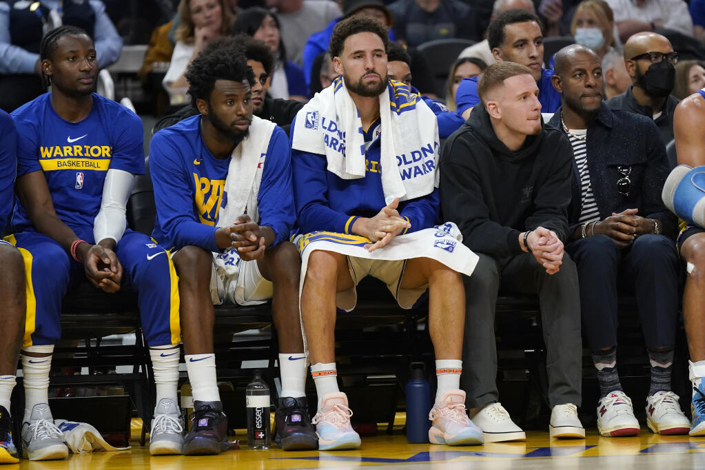 Golden State Warriors forward Jonathan Kuminga, from left, forward Andrew Wiggins and guard Klay Thompson during an. Oct. 27 game against the Miami Heat in San Francisco. (Jeff Chiu / ASSOCIATED PRESS)