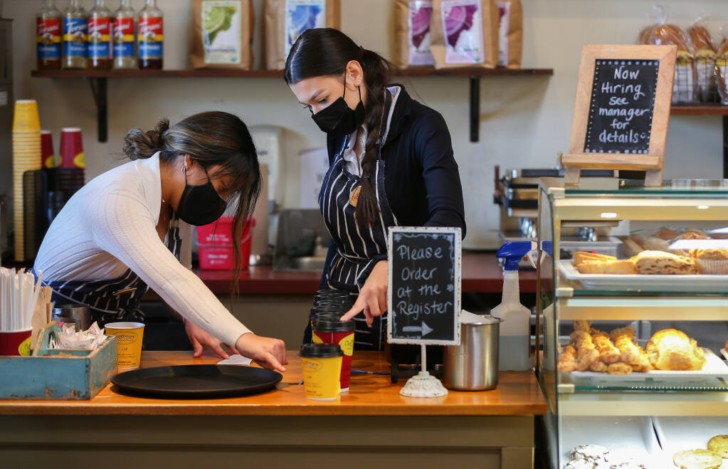 Sofie Johnson, left, and Destiny Wright sort out a drink order at Costeaux French Bakery in Healdsburg on Thursday, May 20, 2021.  (Christopher Chung/ The Press Democrat)