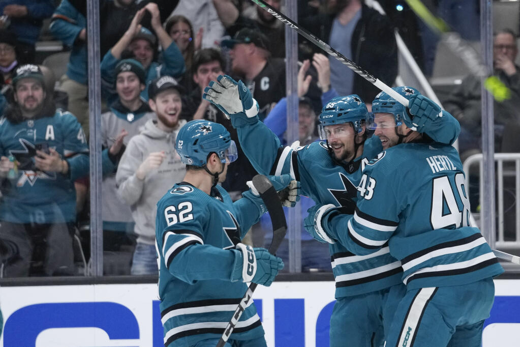 Sharks defenseman Erik Karlsson, middle, celebrates with right wing Kevin Labanc, left, and center Tomas Hertl after scoring a goal against the Colorado Avalanche during the first period in San Jose, Thursday, April 6, 2023. (Godofredo A. Vásquez / ASSOCIATED PRESS)