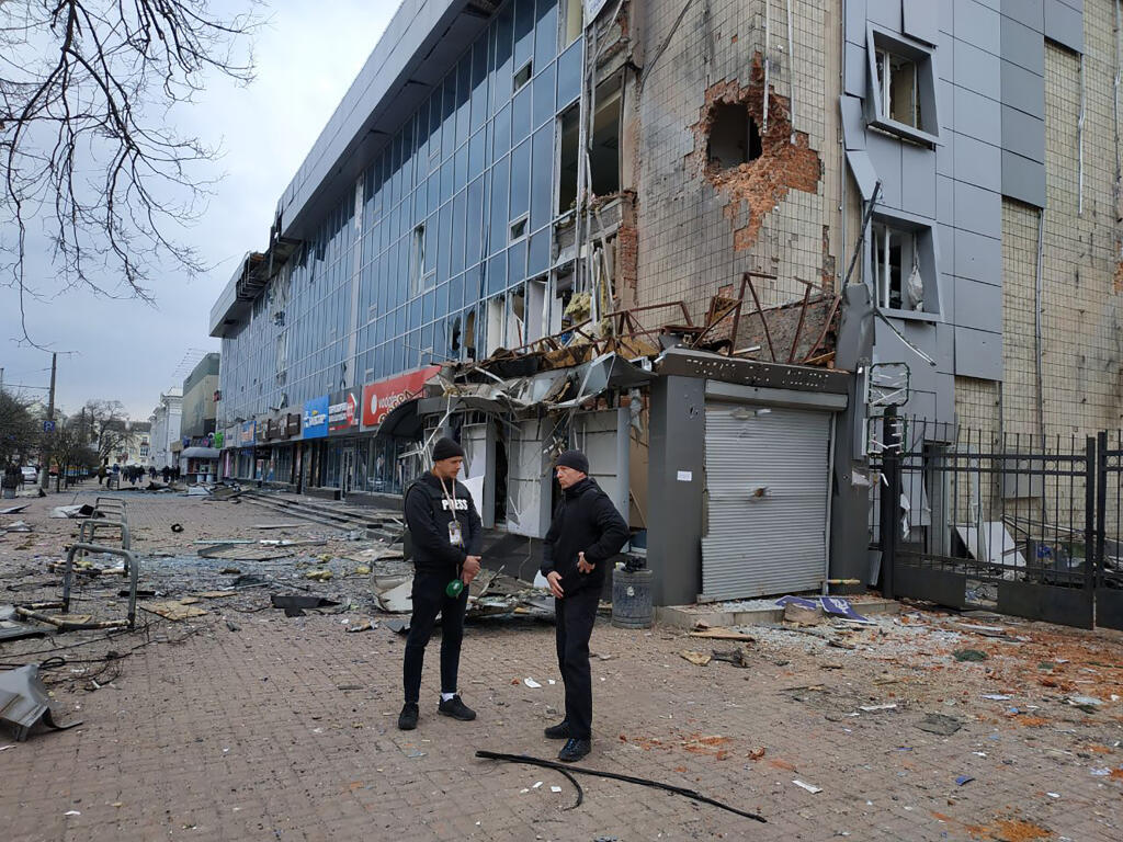 Mayor of Chernihiv Vadyslav Atroshenko, right, speaks to a journalist near the shopping mall damaged by night shelling in Chernihiv, Ukraine, Wednesday, March 30, 2022. Ukrainian officials say Russian forces pounded areas around Kyiv and another Ukrainian city overnight. The attacks come hours after Moscow pledged to scale back military operations in those places.(AP Photo/Vladislav Savenok)
