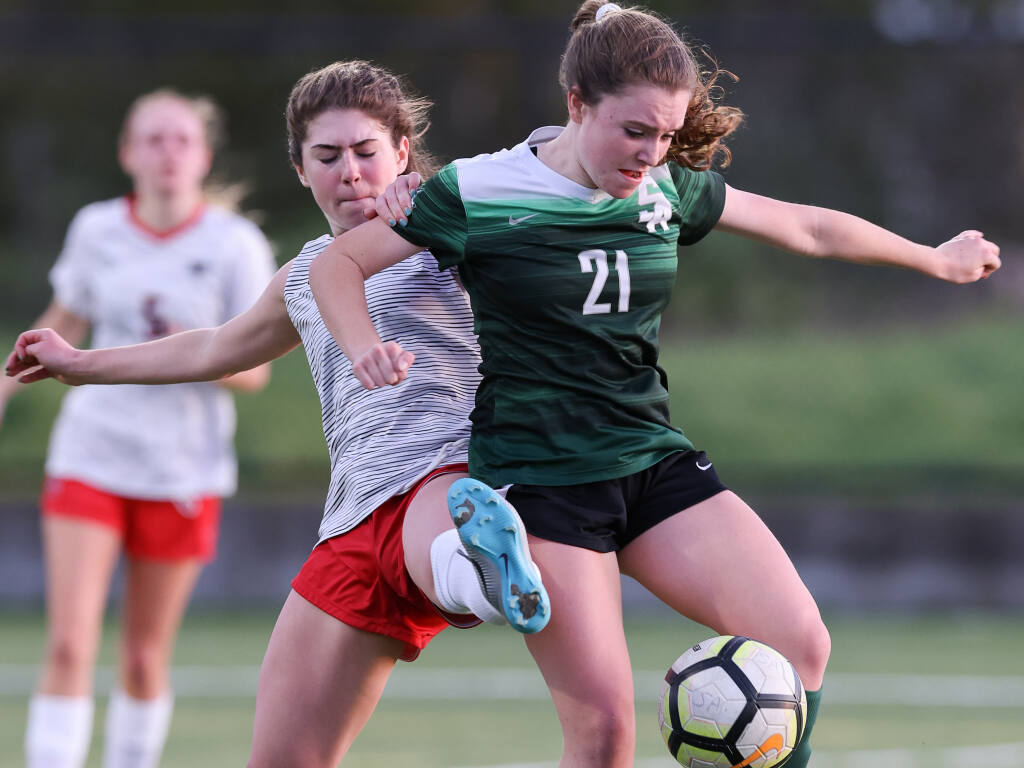 Sonoma Academy's Kate Bruntlett, right, keeps the ball away from Marin Academy's Elodie Mortimer during their match in Santa Rosa on Friday, January 21, 2022.  (Christopher Chung/ The Press Democrat)