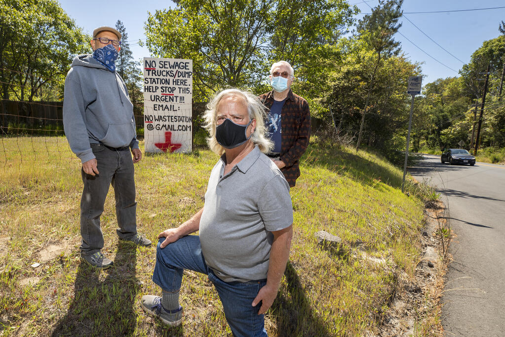 From left, Jacob Harris, David Johnson and Steve Lochner oppose the town of Graton's plan to truck in  4,200-gallon loads of wastewater 30 times a week from Occidental to a receiving station next to their homes on the corner of Green Valley Road and Hicks Roadd. Occidental's sewage is presently trucked to Windsor but Graton hopes to increase revenue from its underutilized sewage plant. Photo taken on Wednesday, April 14, 2021.  (John Burgess/The Press Democrat)