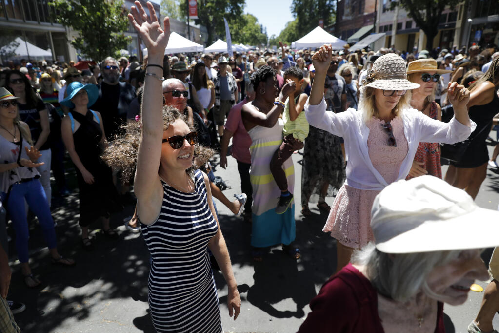 Heather Noyes, left, dances to the music of Sol Horizon during the 4th annual Railroad Square Music Festival in Santa Rosa on Sunday, June 10, 2018. (Beth Schlanker/ The Press Democrat)
