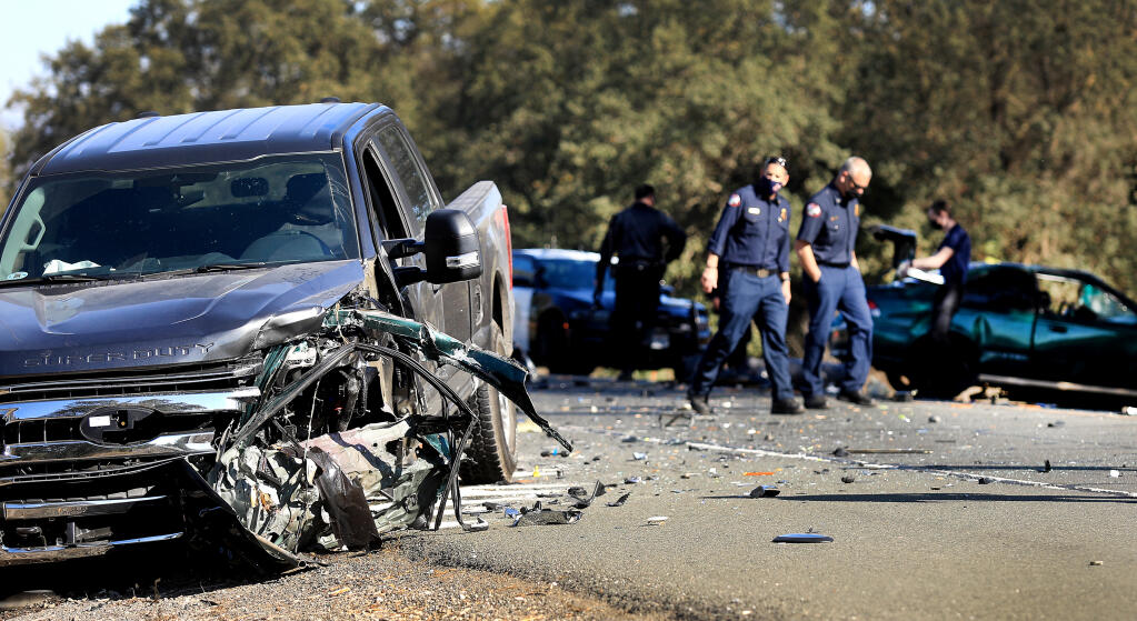 The aftermath of a fatal traffic collision between a Ford pickup and a Honda Civic, background that closed Highway 12 at Merced Avenue in Santa Rosa, Monday, Nov. 2, 2020.  (Kent Porter / The Press Democrat)