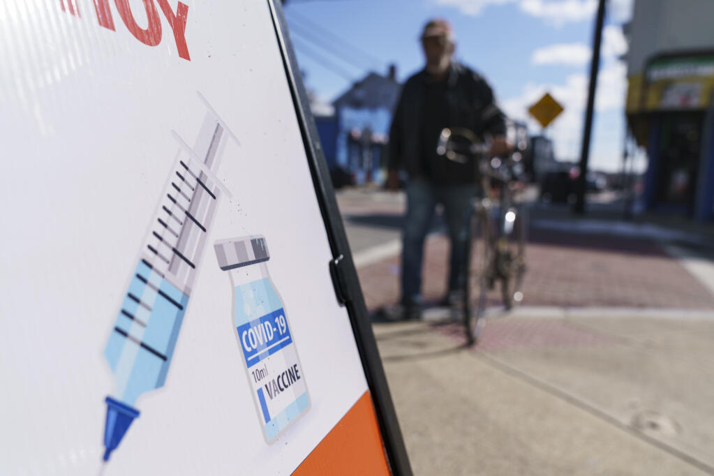 A sign promoting available COVID-19 vaccines stands outside a vaccination clinic in Providence, R.I., Thursday, March 3, 2022. (AP Photo/David Goldman)