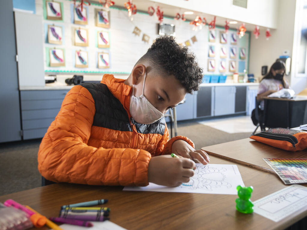 Hayden Dodd, Village Elementary School third grader, colors a drawing during independent study in Sarah McBride’s class in Santa Rosa, Monday February 28, 2022. (Chad Surmick / The Press Democrat)