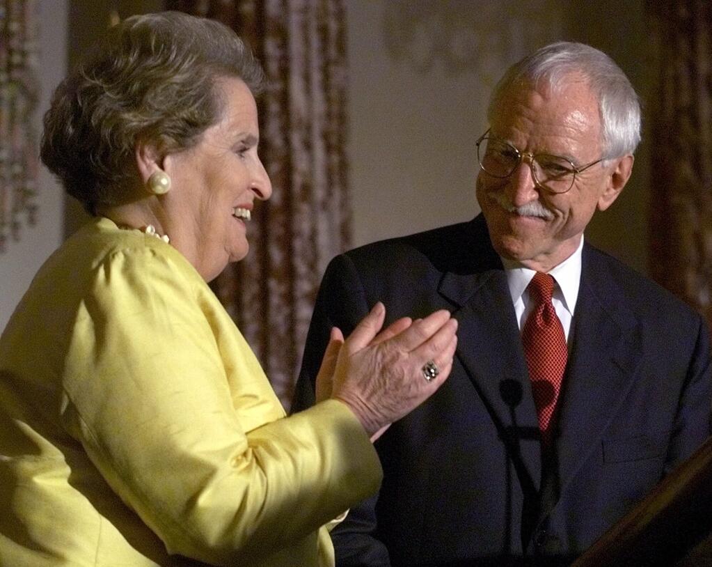 FILE - In this June 29, 1999, file photo, Secretary of State Madeleine Albright, left, applauds James C. Hormel as the new ambassador to Luxembourg at a State Department ceremony in Washington. Hormel, who became the nation's first openly gay ambassador, died in San Francisco, Friday Aug. 13, 2021. Hormel who was appointed to be the ambassadorship by President Bill Clinton in 1997, was 88. (AP Photo/Khue Bui, File)