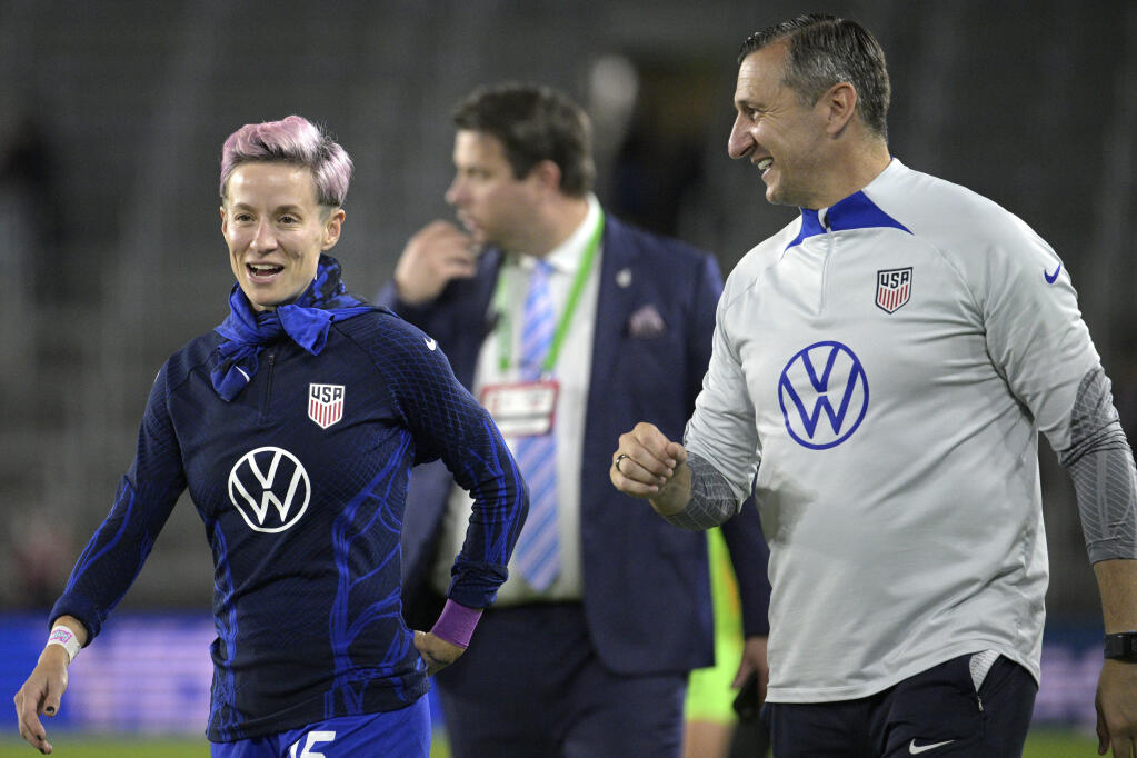 U.S. coach Vlatko Andonovski, right, and forward Megan Rapinoe (15) laugh after the team's win against Canada during a SheBelieves Cup soccer match Thursday, Feb. 16, 2023, in Orlando, Fla. (AP Photo/Phelan M. Ebenhack)