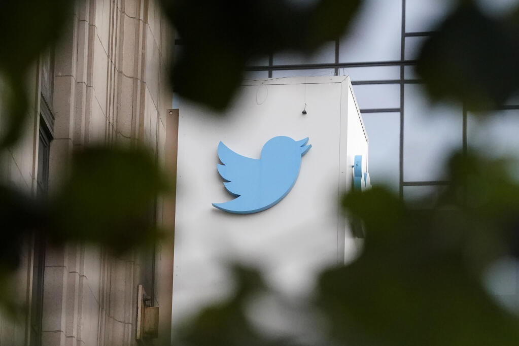 FILE - A sign at Twitter headquarters is shown in San Francisco, Dec. 8, 2022. Twitter says it has removed thousands of tweets showing a poster promoting a “trans day of vengeance” protest in support of transgender rights in Washington, D.C., on Saturday, March 25, 2023. (AP Photo/Jeff Chiu, File)