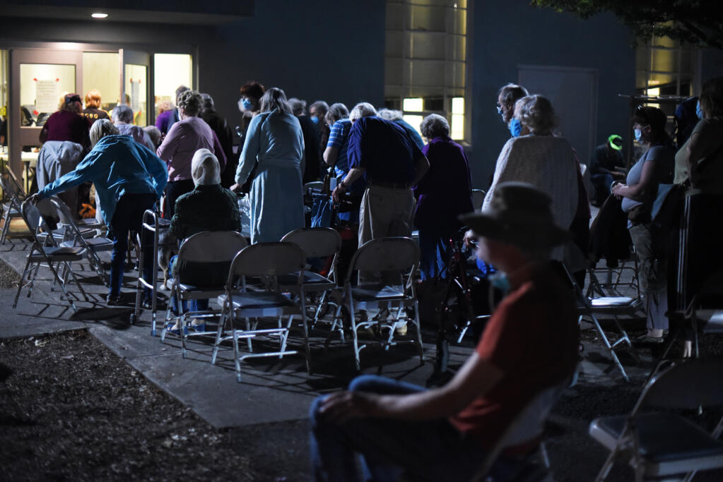 Hundreds of elderly residents, many from Spring Lake Village and Oakmont Gardens senior living centers, wait to enter the Veterans Memorial Auditorium in Santa Rosa on Monday, Sept. 28, 2020. Hardening the county’s infrastructure, including its evacuation centers, against such disasters is a priority in the county’s five year plan. (Erik Castro / For The Press Democrat)